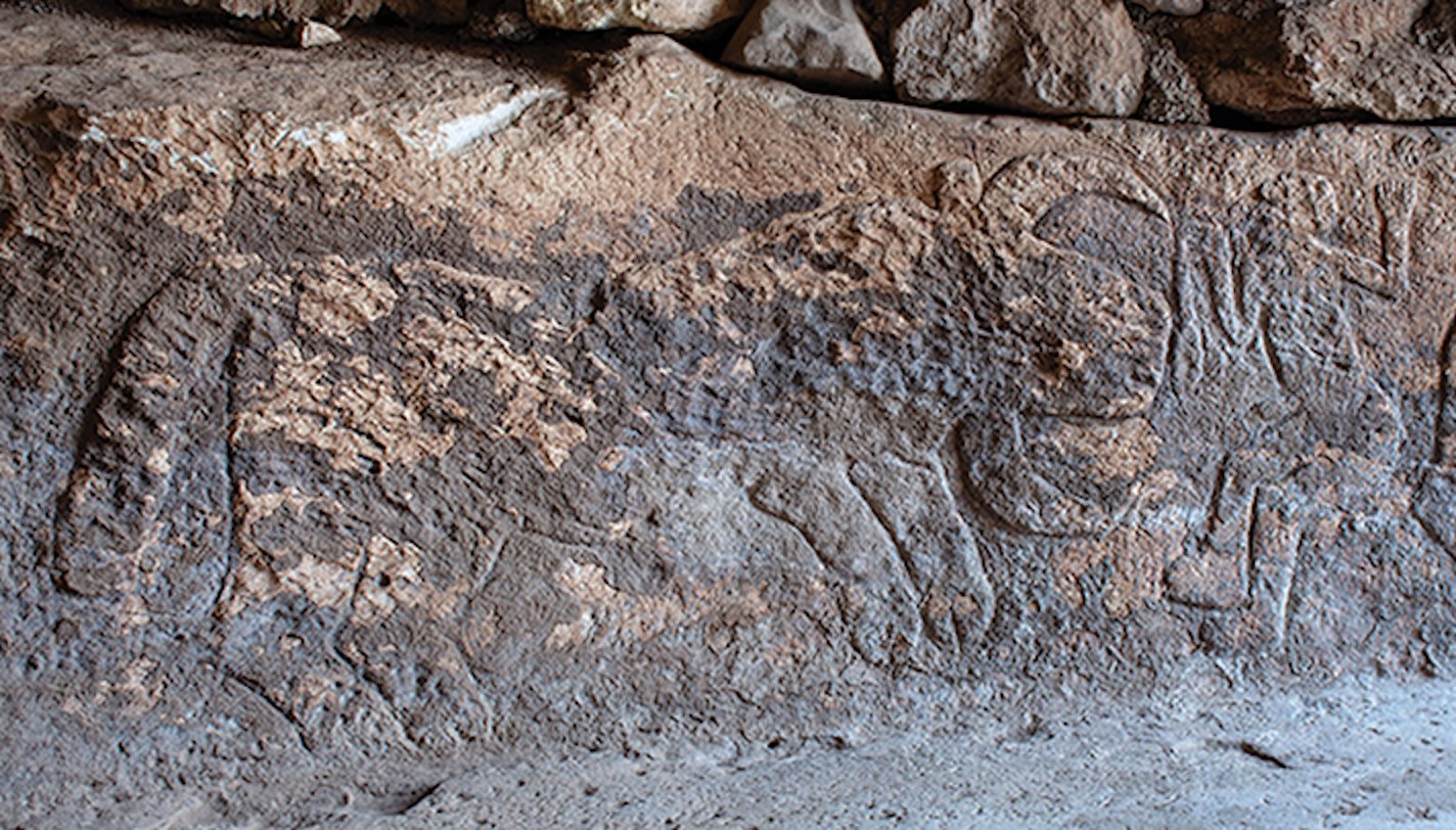 The bull-human scene of the Sayburç relief in situ, a crouching man beside a large horned bull