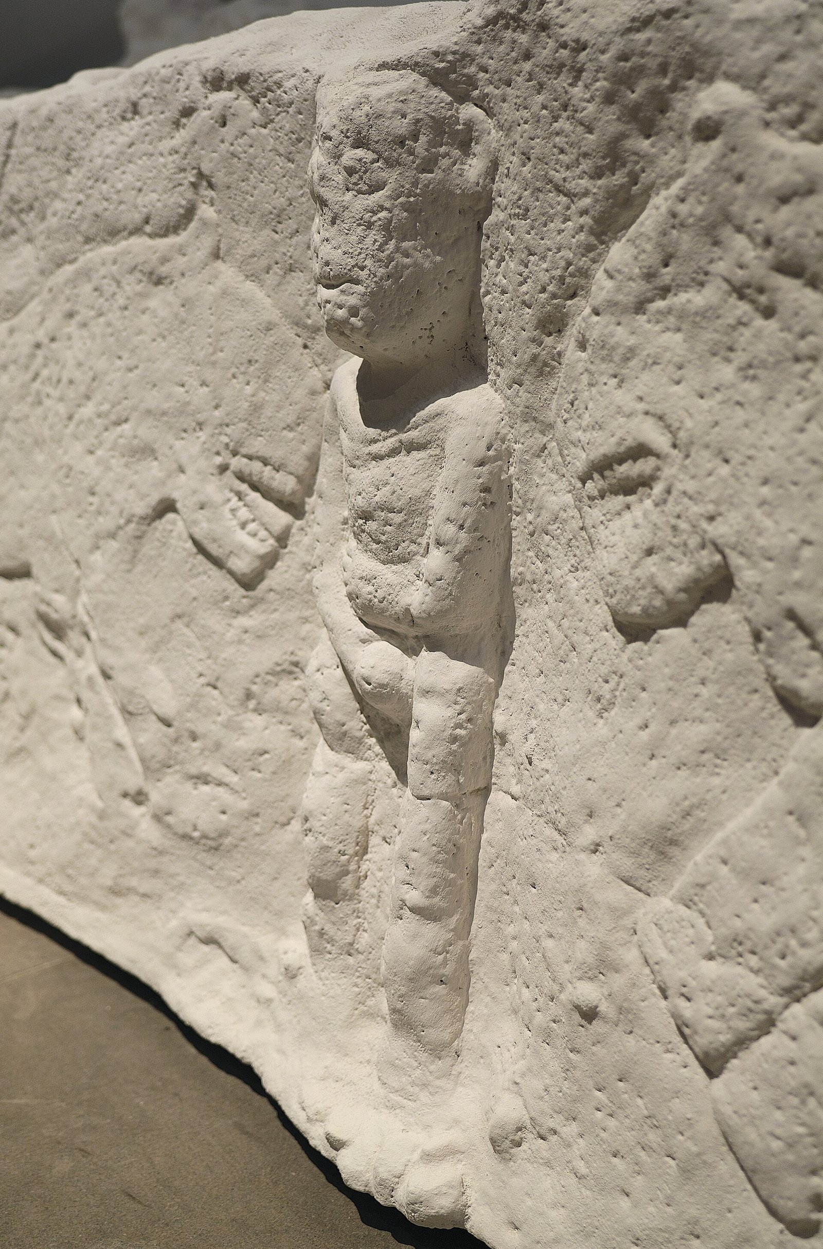 Close-up of the central male figure of the Sayburç relief, shown in high relief holding himself with both hands