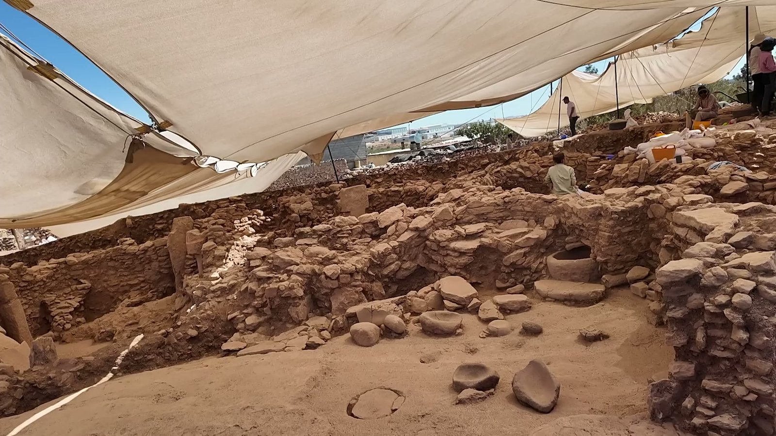 Stone vessels found in situ at the excavation, of the kind linked to food processing and feasting